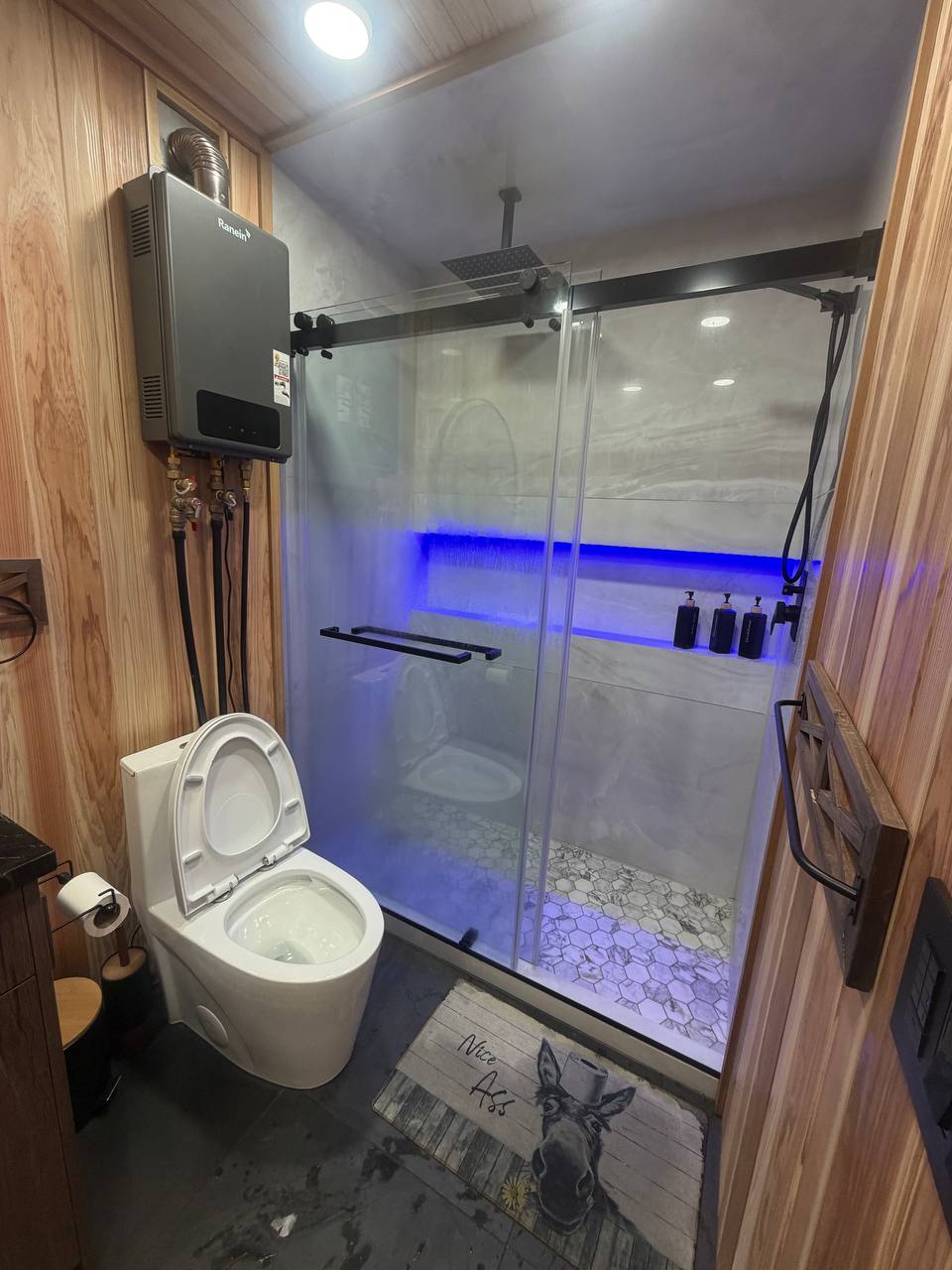 LED lit shower with glass partition