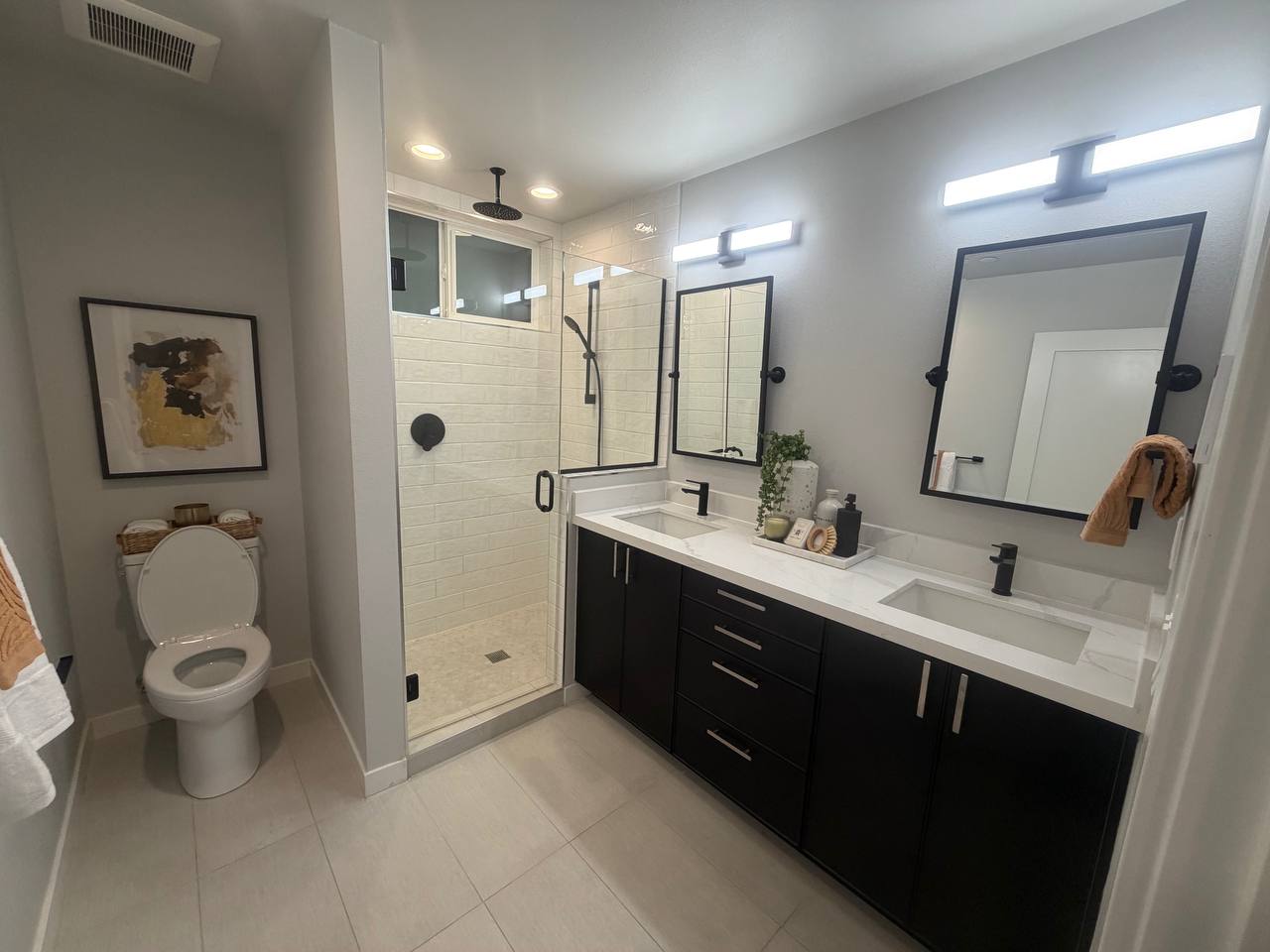 Full bathroom dark vanity walk-in shower