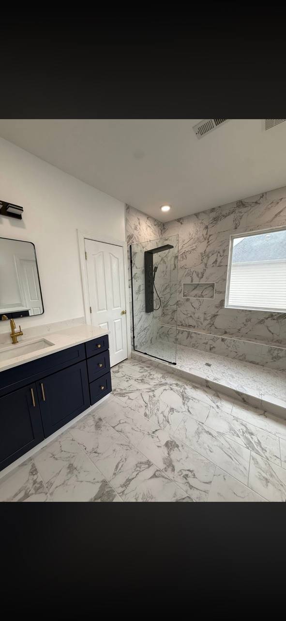 Marble tile shower navy vanity